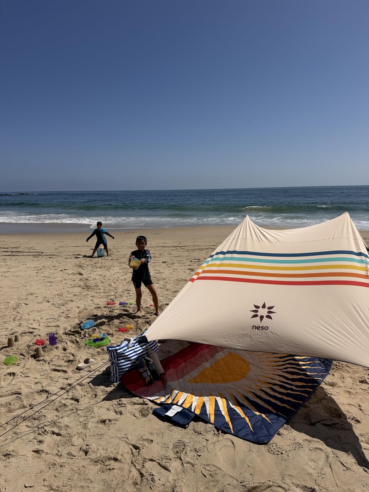 Neso Portable Beach Tent Sun Shelter with Sand Anchor - Lightweight Beach Shade Canopy - Easy Setup for Family Outings - Patented Reinforced Corners - UPF 50+ Sun Protection - 7 x 7ft - Rainbow customer photo 2